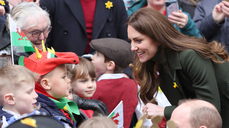 Kate Middleton talking to a group of kids