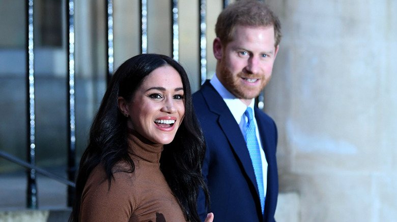 A smiling Meghan Markle and Prince Harry walking together