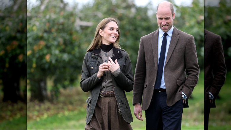 Kate Middleton and Prince William in shades of brown and earth tones while walking outside
