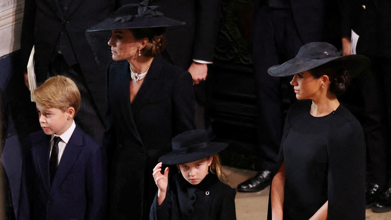 Kate and Meghan at the funeral with Prince George and princess Charlotte