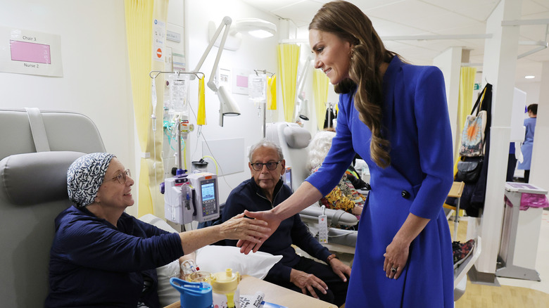 Kate Middleton talking to cancer patients and shaking hands.