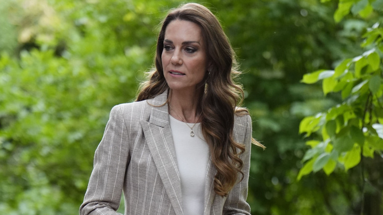 Kate Middleton walking outdoors.