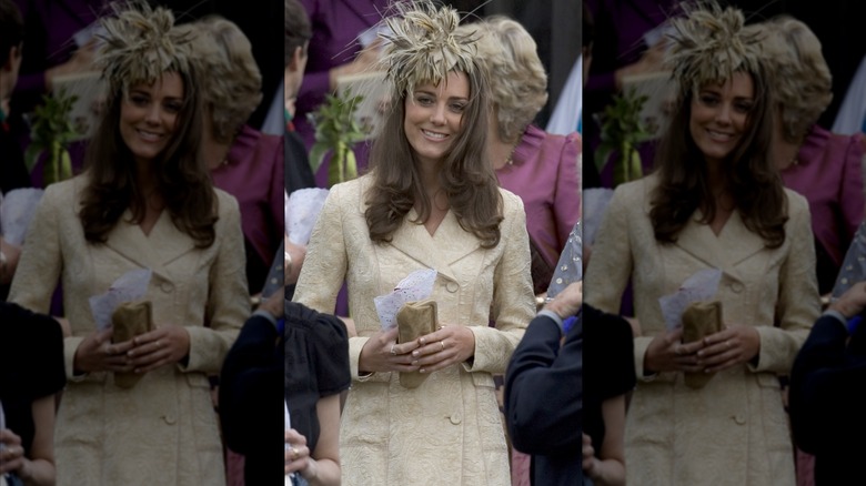 Princess Catherine wearing a coat dress and feather fascinator.