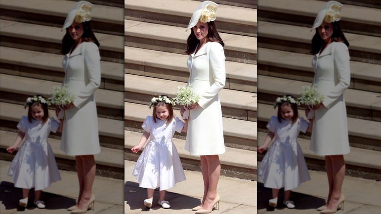 Princess Catherine holding Princess Charlotte's hand.