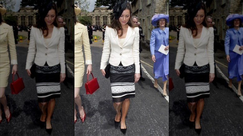 Princess Catherine wearing a white coat and black and white lace skirt.