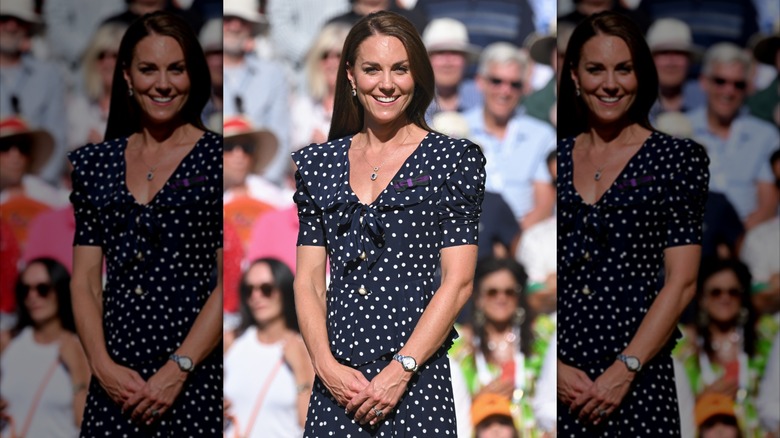 Princess Catherine wearing a navy, short-sleeved dress with white polka dots and a sailor collar