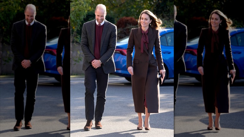 Princess Catherine wearing a maroon polka dot dress with bow and matching coat with Prince William in gray suit and maroon vest