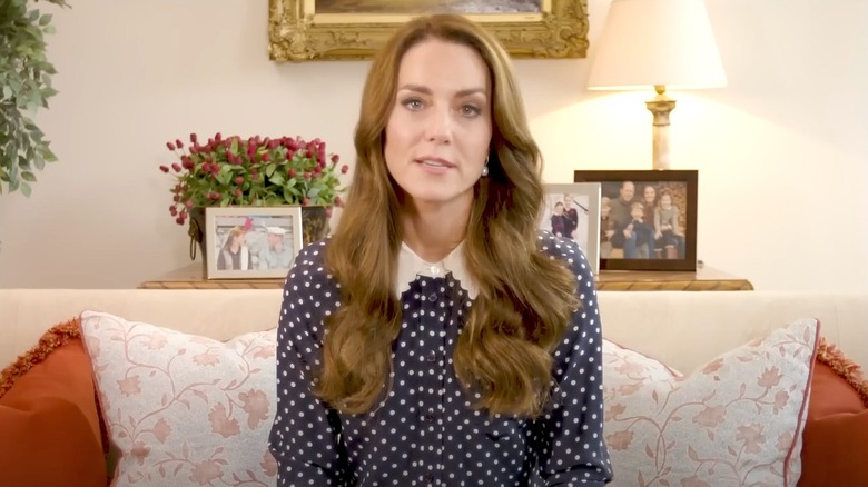 Princess Catherine in navy and white polka dot blouse with white scalloped collar