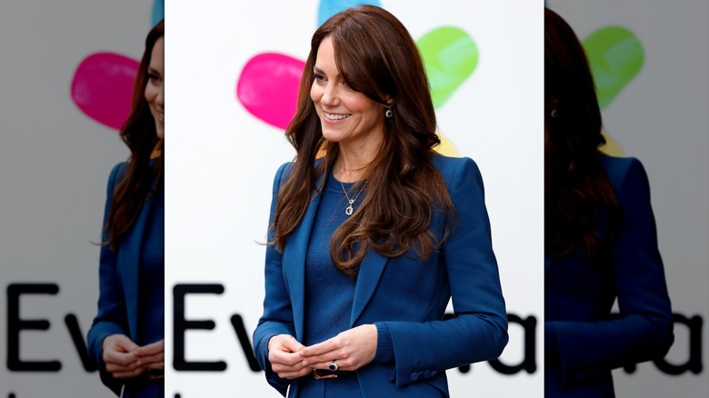 Kate Middleton smiling in a teal suit