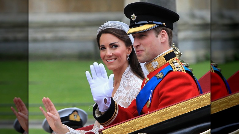 Kate Middleton and Prince William in a carriage in wedding attire waving