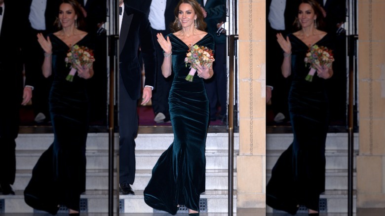 Kate Middleton walking down stairs, holding flowers and waving