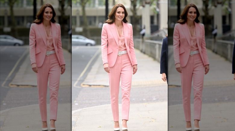 Kate Middleton strutting down the street in a pastel pink pantsuit