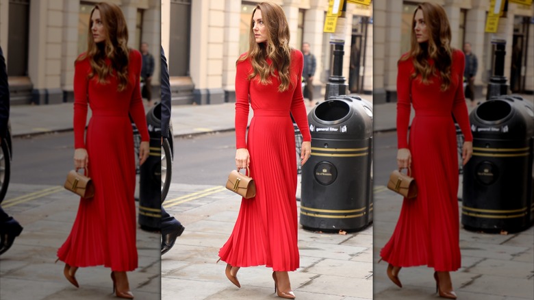 Kate Middleton in a red sweater and red skirt at an event