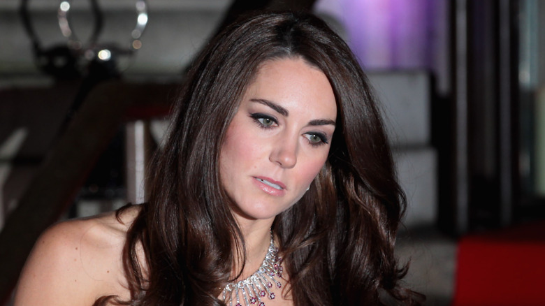 Kate Middleton wearing a black dress and silver necklace while attending the Sun Military Awards at the Imperial War museum.