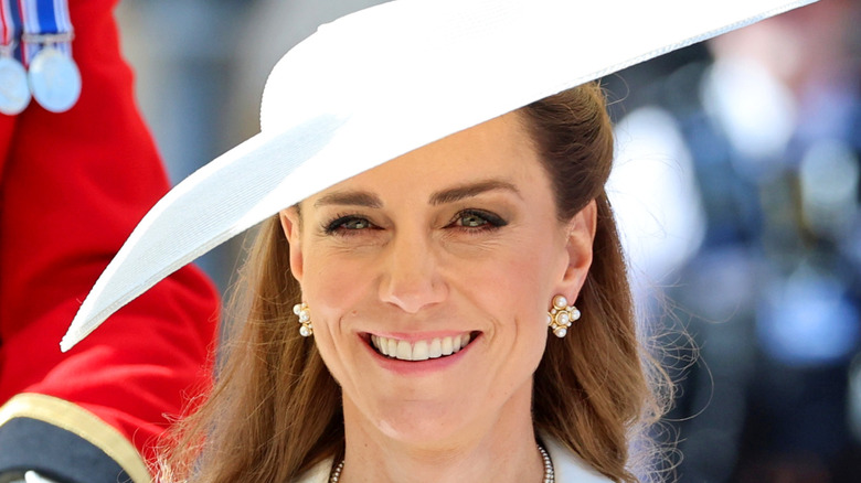 Kate Middleton smiling in a white hat