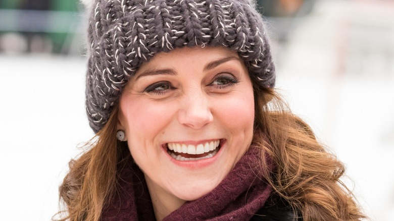 Kate Middleton laughing in a woollen hat