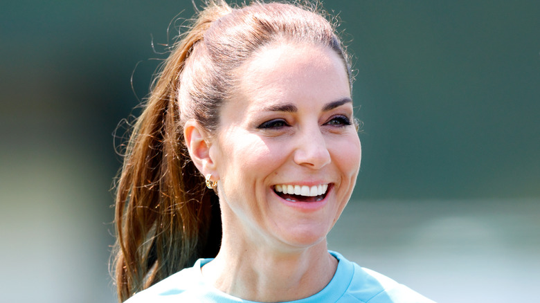 Kate Middleton ponytail blue rugby shirt