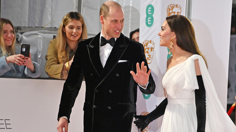 Catherin, Princess of Wales, taps her husband, William, Prince of Wales, on the bum in a photo from the 2023 BAFTA Film Awards