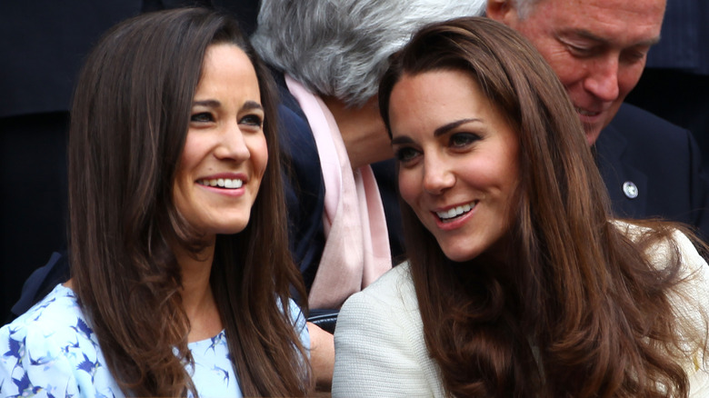 Pippa and Kate Middleton talking and smiling