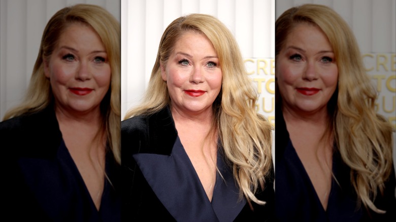 Christina Applegate smiling in a black blazer with her hair down