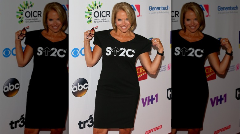 Katie Couric showing off Stand Up to Cancer shirt