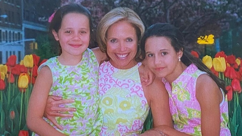 Katie Couric posing with her young daughters