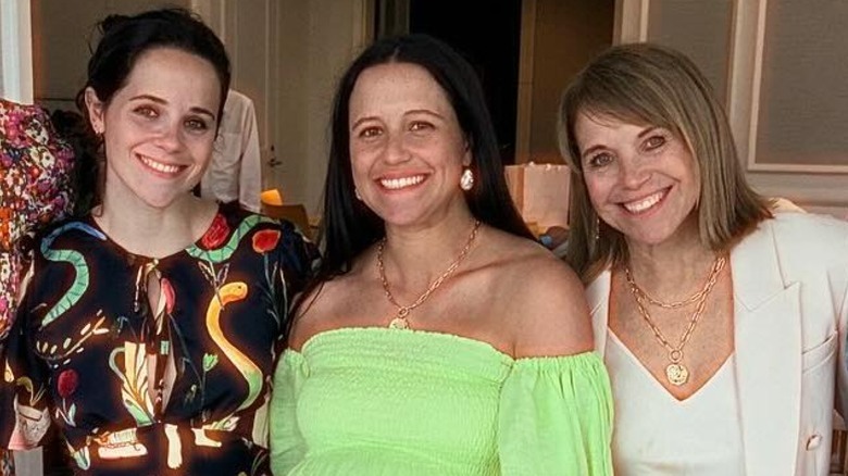 Katie Couric smiling with her daughters Ellie and Carrie Monahan