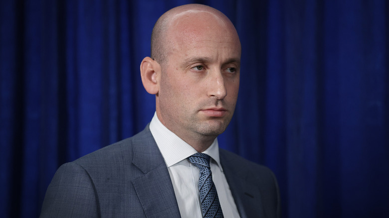 Stephen Miller serious expression looking to his left