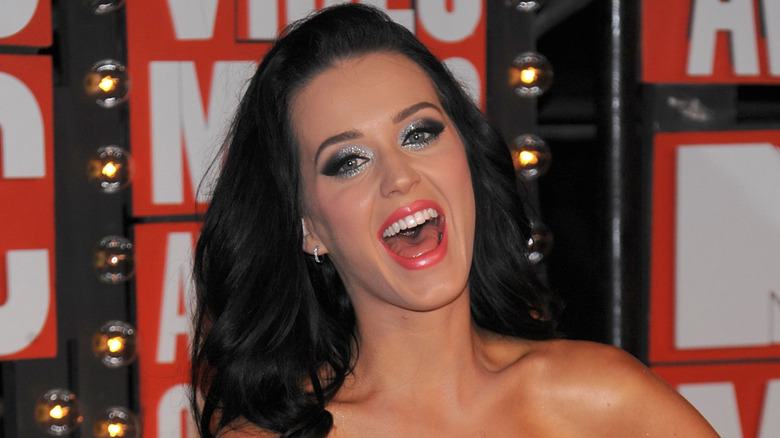 Katy Perry laughing close-up with silver eye shadow.