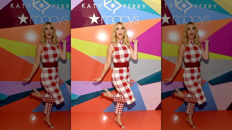 Katy Perry posing on a red carpet at the launch of her shoe collection at Macy's