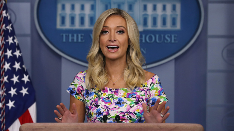 Kayleigh McEnany holding a press conference in a bright floral dress