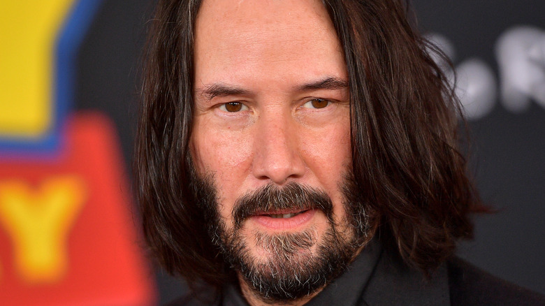 Keanu Reeves poses on the red carpet