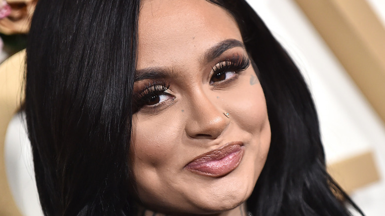 Kehlani grinning with nose ring