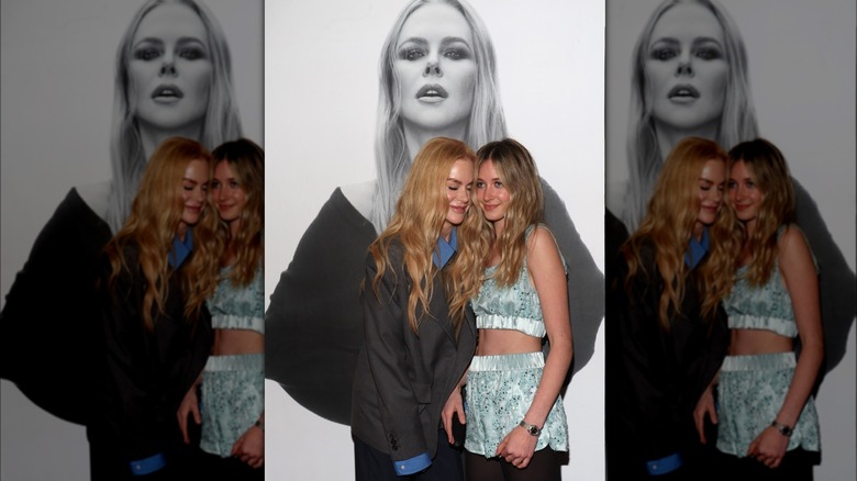 Sunday Rose Urban and Nicole Kidman standing in front of black and white photo of Kidman
