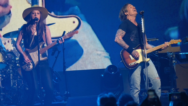 Maggie Baugh and Keith Urban performing together on stage