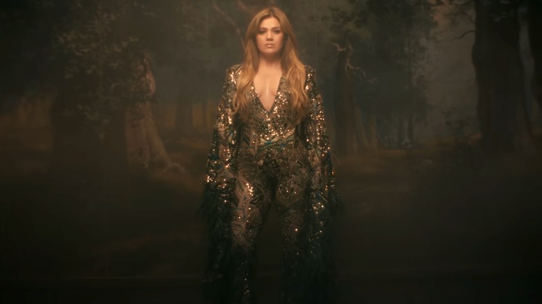 Kelly Clarkson wearing low-cut, sparkly jumpsuit in her music video for "Where Have You Been"