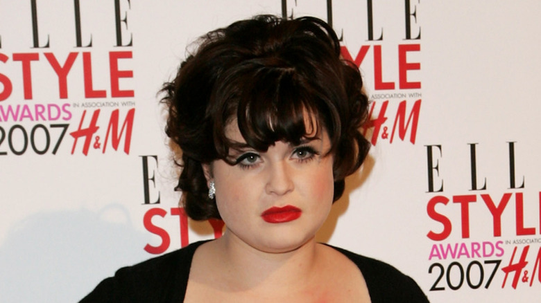 Kelly Osbourne with high black hair and bangs
