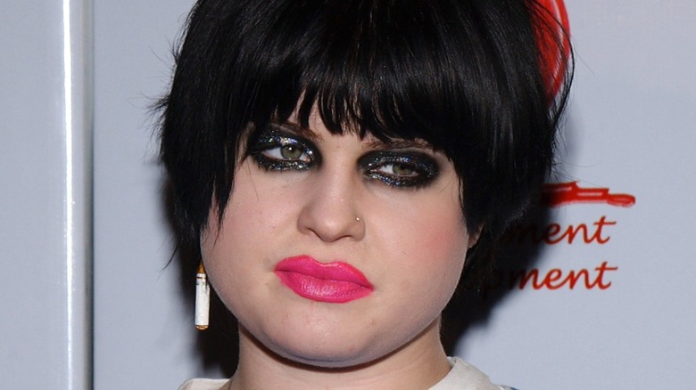 Kelly Osbourne with a black, sparkly panda eye and over lined hot pink lips