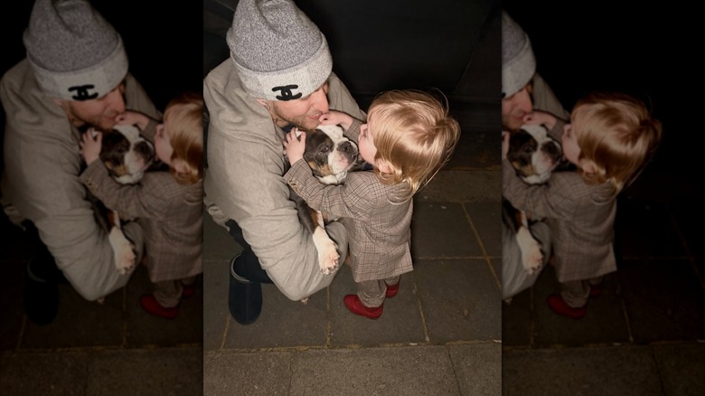 Miles Langford and Sidney Osbourne-Wilson with a dog between them