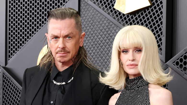 Sid Wilson and Kelly Osbourne posing together at an event