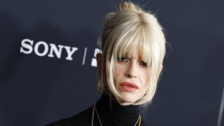 Kelly Osbourne posing at the 2026 Pre-Grammy Gala in a black turtleneck