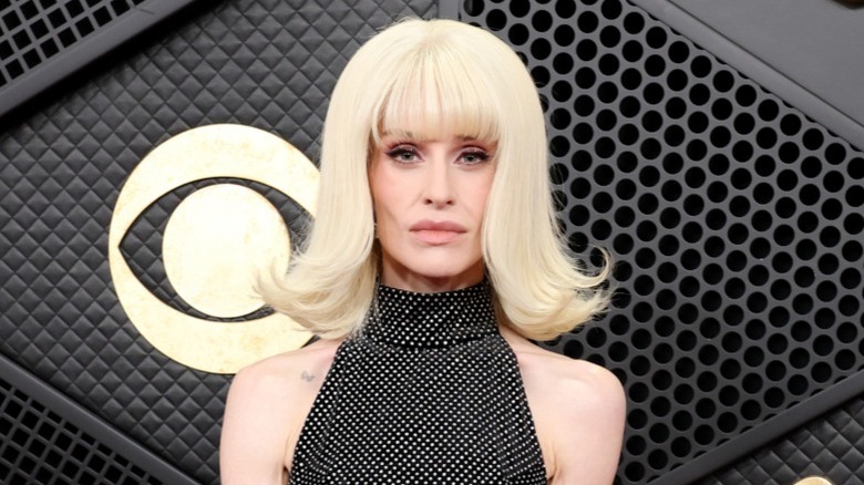 Kelly Osbourne posing in a black polka dot dress while attending the 2026 Grammy Awards