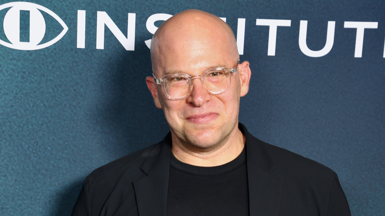 Benjamin Cavell wearing a black suit and glasses