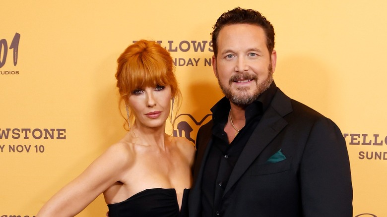 Kelly Reilly and Cole Hauser in matching black formal outfits.