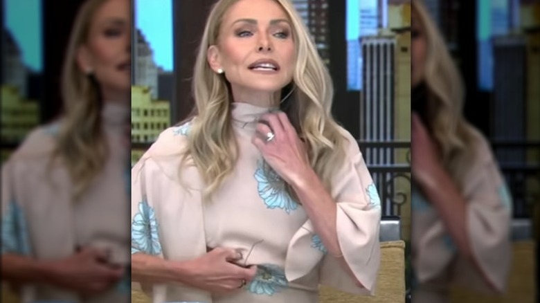 Kelly Ripa adjusting dress