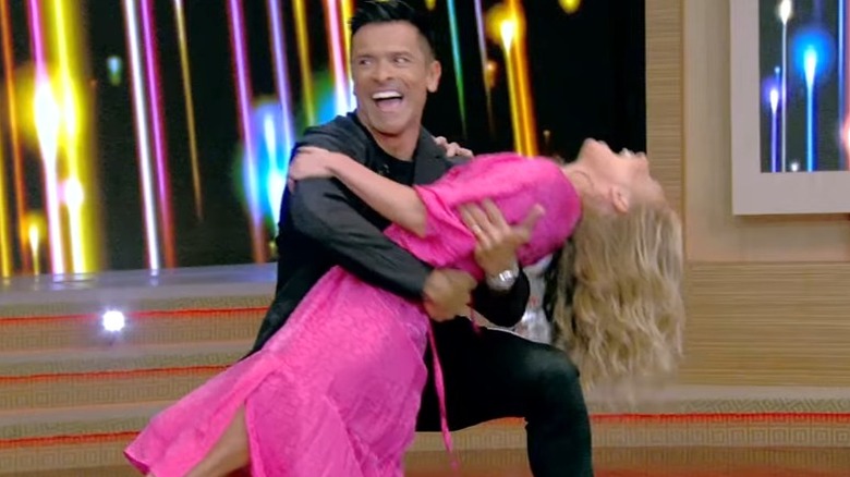 Kelly Ripa dancing in a pink dress