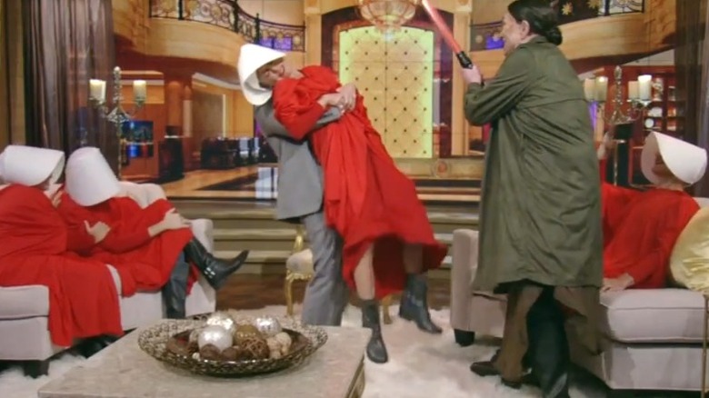 Kelly Ripa being picked up in red Handmaid's Tale costume