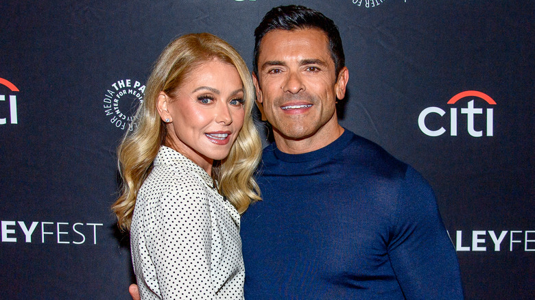 Kelly Ripa and Mark Consuelos embrace on the red carpet