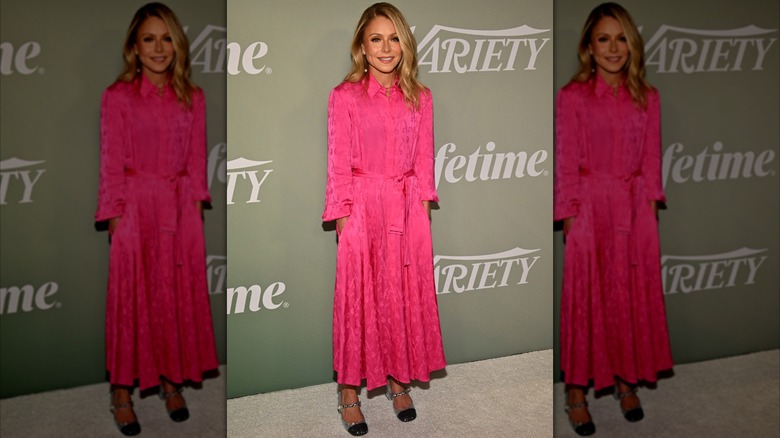 Kelly Ripa wearing a collared pink dress with a tie belt and glitter Mary Janes in silver and black