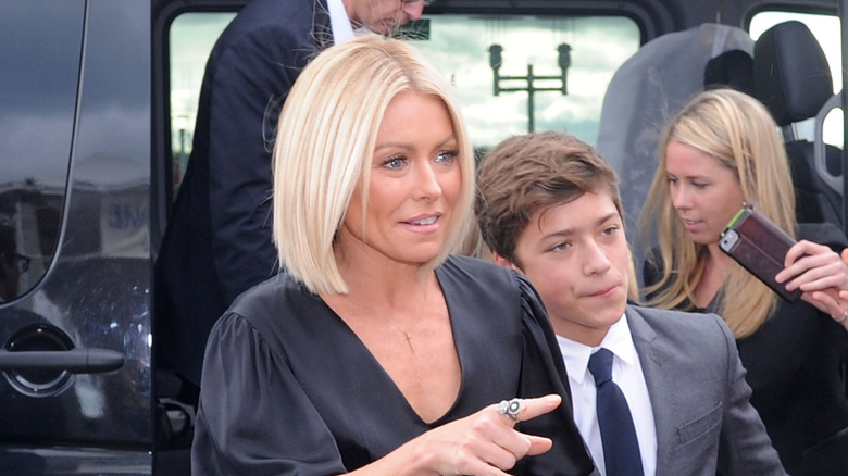 Kelly Ripa and Michael Consuelos.looking away from camera